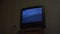 Retro tv set with broken noise analogue broadcast on black screen