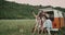 Retro van in the middle of nature, group of beautiful ladies taking selfies, sitting on the back of the van , happy