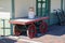 Retro vintage antique railway train warehouse building with red and green luggage wheel card on a red brick loading platform