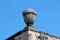 Retro vintage old concrete roof decoration in shape of large flower pot on corner edge of abandoned movie theater