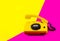 Retro vintage phone handset yellow pink red purple plastic orange disko background old style shadow 90 answer reply raised