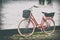 Retro vintage red bicycle on cobblestone street in the old town.