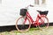 Retro vintage red bicycle on cobblestone street in the old town.