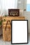 Retro vintage transistor radio is on a wooden locker which there is a blank white frame for text  advertisement .Interior vintage