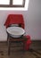 Retro washing basin on a chair with red towel