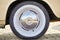 Retro wheel of the classic car in the old style. Oldtimer. White painted tire stylized as an old tire. A car from the 50s