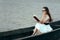 Retro Woman Reading a Book in a Vintage Boat