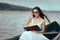 Retro Woman Reading a Book in a Vintage Boat