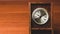 Retro wooden clock. square shaped vintage clock with round dial. wood table