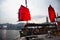 Retro wooden ship or Chinese junk boats for travelers people looking view of Hong Kong and Kowloon island at Victoria Harbour