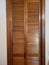 Retro wooden slatted bifold folding closet doors in wood