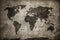 Retro world map on concrete, plaster wall. Vintage, grunge background.