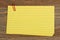 Retro yellow paper index cards stack with paper clip on wood desk