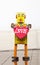 Retro yellow robot toy holding a red heart