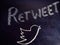 retweet word displayed on chalkboard concept with logo