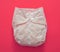 Reusable cloth baby diaper. Eco friendly nappy on pink background