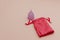 Reusable pastel purple menstrual cup and bag on a pink background. Women's hygiene, menstruation, critical days