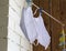 Reusable white medical masks are dried after washing on a clothesline