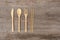 Reusable wooden cutlery. Eco friendly fork, knife, spoon, sticks on an old wooden background. Zero waste concept.