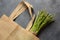 Reusable zero waste textile product bag filled with green asparagus