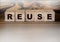 Reuse word written on wooden blocks. Ecology concept