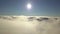 Reveal shot of aerial view from above of white puffy clouds.