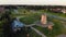 Revealing aerial view traditional lithuanian old wooden XIX century horizontal windmill in open air museum in Siauliai city