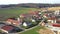 Revealing backward flying aerial view of village in Europe