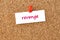 Revenge. Word written on a piece of paper, cork board background