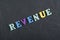 REVENUE word on black board background composed from colorful abc alphabet block wooden letters, copy space for ad text