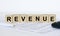 Revenue word concept written on wooden cubes blocks