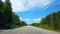 Reverse motion driving rural countryside during bright summer day backward time lapse. Driver point of view POV along beautiful