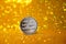 The reverse side of the silver litecoin. Litecoin cryptocurrency is the coin of the future. Golden shiny background.