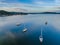 Reverse sunset pale blues waterscape with boats and high cloud