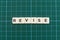 Revise word made of square letter word on green square mat background