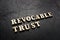 Revocable trust words on the dark background.