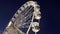 Revolving ferris wheel in night illumination, bottom view