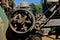 Revolving fly wheel of an old steam powered engine tractor