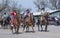 Rex Walker owner of Sombrero Ranch and Miss Colorado Rodeo 2018 riding their horses down main street in Maybell,