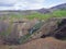 Reykjadalur valley with hot springs river, lush green grass meadow, rocks and hills with geothermal steam. South Iceland near