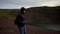 REYKJAVIK, ICELAND, OCTOBER 10, 2019 A guy with a camera walks along the edge of the volcanic lake Kerid