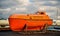 Reykjavik, Iceland - October 14, 2017: maritime safety and survival training centre boat on sea shore. Orange boat or