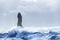 Reynisdrangar basalt rock column in a stormy sea, Iceland