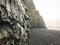 Reynisfjara Beach next to Reynisdrangar sharp basalt rock cliffs next to black beach