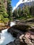 Reynolds Creek Falls rushes beside the Gunsight Pass Trail, Glacier National Park