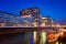 Rheinauhafen water promenade in Cologne Koeln marina at night with boats on the water, Germany