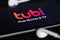 Rheinbach, Germany  28 April 2022,  The brand logo of the streaming service `Tubi` on the display of a smartphone with headphones