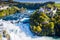 Rhine Falls or Rheinfall, Switzerland panoramic aerial view. Tourist boat in waterfall. Bridge and border between the cantons