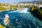 Rhine Falls Rheinfall, Switzerland panoramic aerial view. Tourists boats in waterfall. Cliff-top Schloss Laufen castle, Laufen-