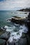 Rhode Island Cliff Walk shows breaking waves along the rocky shoreline of the Atlantic Ocean